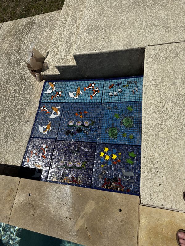 Hand-cut mosaic tiles staged in the studio before installation